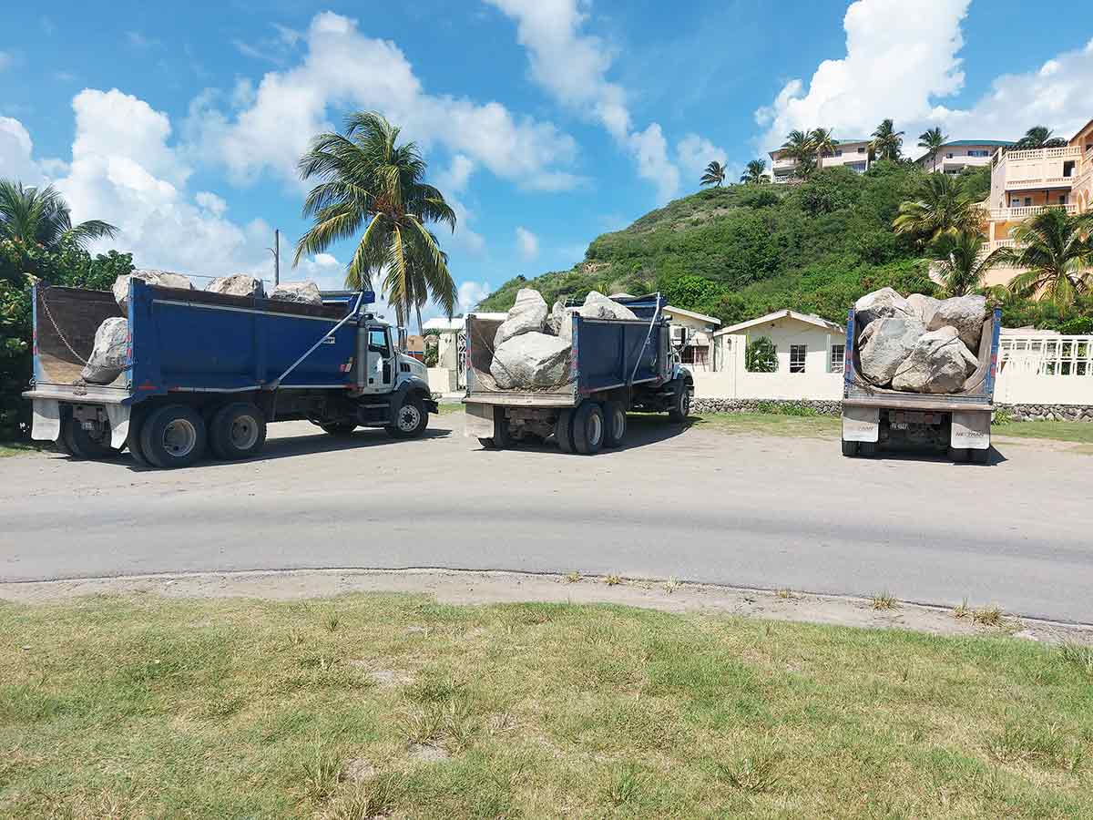 Trucks unloading boulders at Frigate Bay